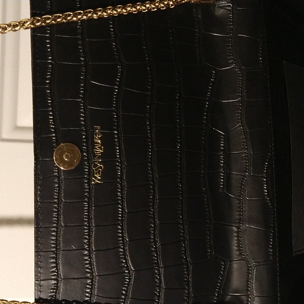 Auth. Yves Saint Laurent women's handbag. It's a 6 1/2 w ×11" L Width. 28" long.